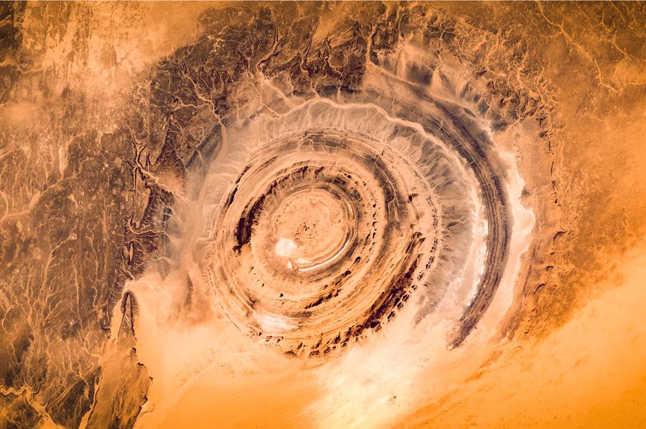 Cấu trúc Richat, Mauritanie Các phi hành gia đã theo dõi Cấu trúc Richat - còn được gọi là Con mắt của Sahara - ở Ouadane kể từ khi con người lần đầu tiên bước vào vũ trụ. Nhìn từ Trạm vũ trụ quốc tế, vòng xoáy rộng 30 dặm (48,2km) giống như mắt bò hoặc vỏ ốc sên. Điều kỳ lạ về địa chất được cho là một miệng núi lửa do thiên thạch gây ra nhưng giờ đây người ta cho rằng nó từng là một mái vòm đã bị xói mòn theo thời gian