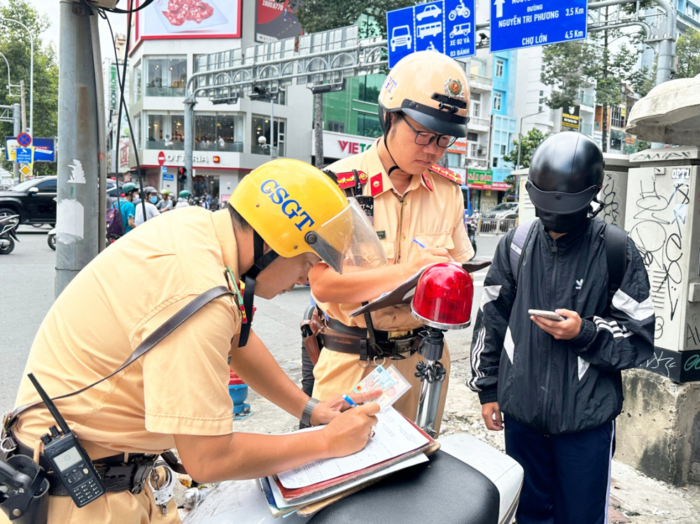 Một học sinh điều khiển xe máy trên 50cc đến trường bị Đội Cảnh sát giao thông Bến Thành xử phạt vào đầu tháng 10/2023 - ẢNH: THIÊN ÂN