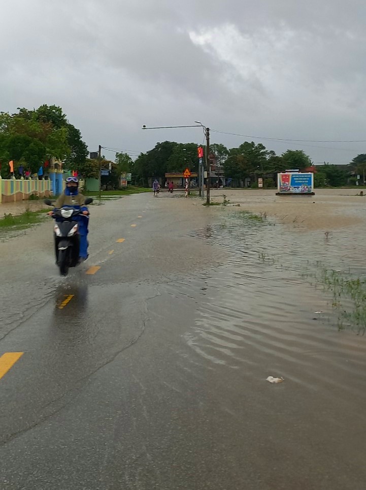 Nước lũ bắt đầu tràn lên đường trường THPT Trần văn Kỷ huyện Phong Điền (Thừa Thiên Huế) cho học sinh nghỉ học