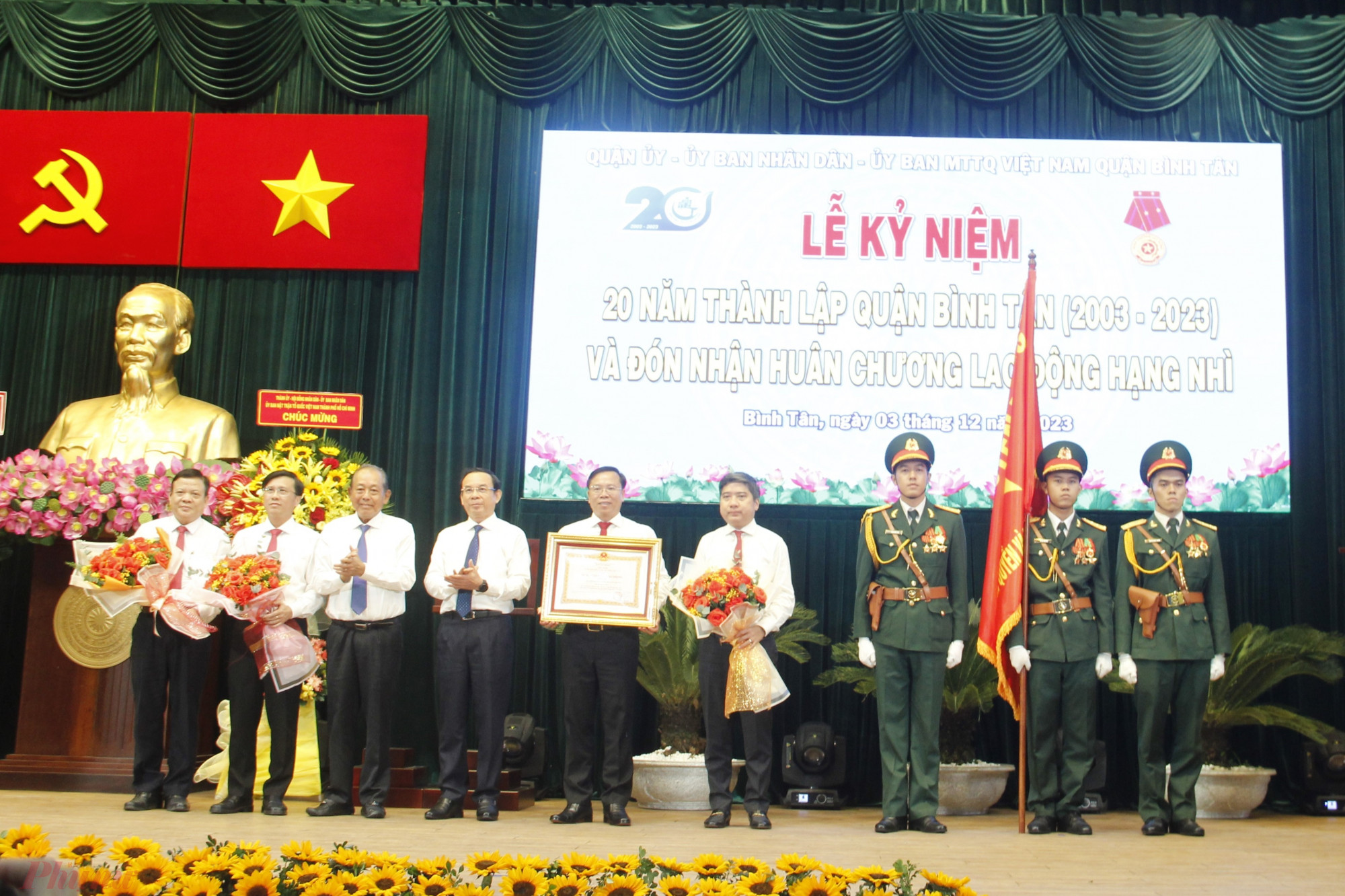 Bí Thư Thành ủy TPHCM Nguyễn Văn Nên (thứ tư từ trái sang), nguyên Phó Thủ tướng Thường trực Chính phủ Trương Hòa Bình (thứ ba từ trái sang) trao Huân chương Lao động hạng Nhì và tặng hoa chúc mừng lãnh đạo quận Bình Tân.