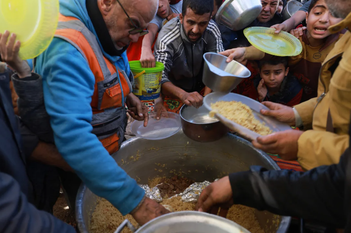 Người Palestine di tản xếp hàng nhận quyên góp thực phẩm ở thành phố Rafah, phía nam Dải Gaza vào ngày 30/11.