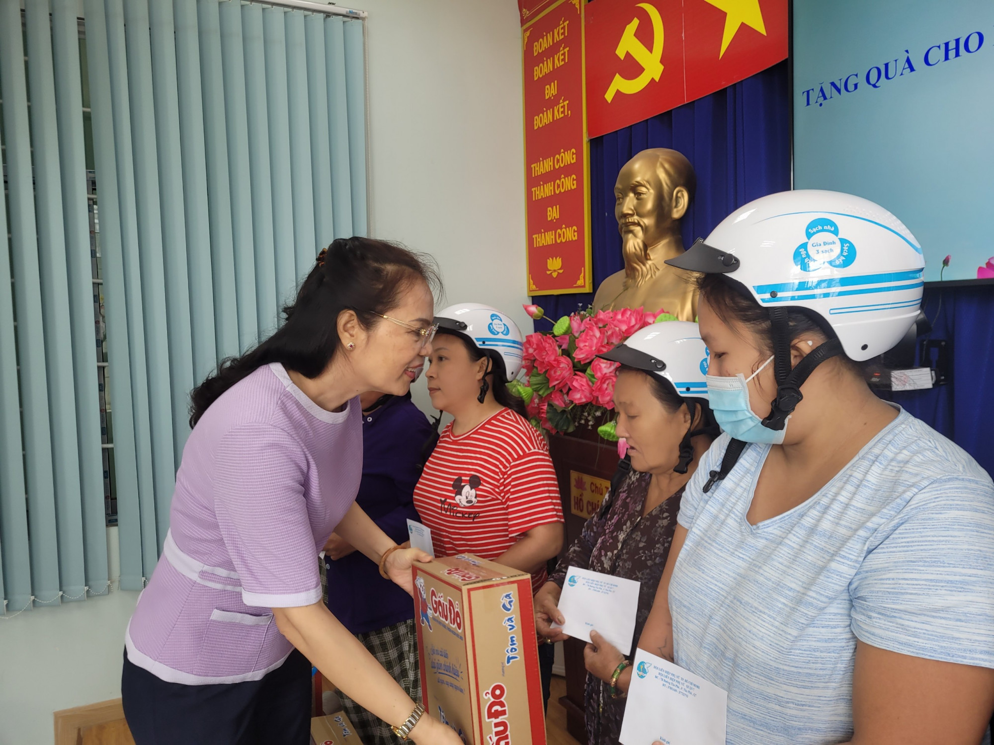 Bà Huỳnh Nguyệt Ánh - Chủ tịch Hội LHPN quận 7 - trao quà tết cho các phụ nữ hồi gia