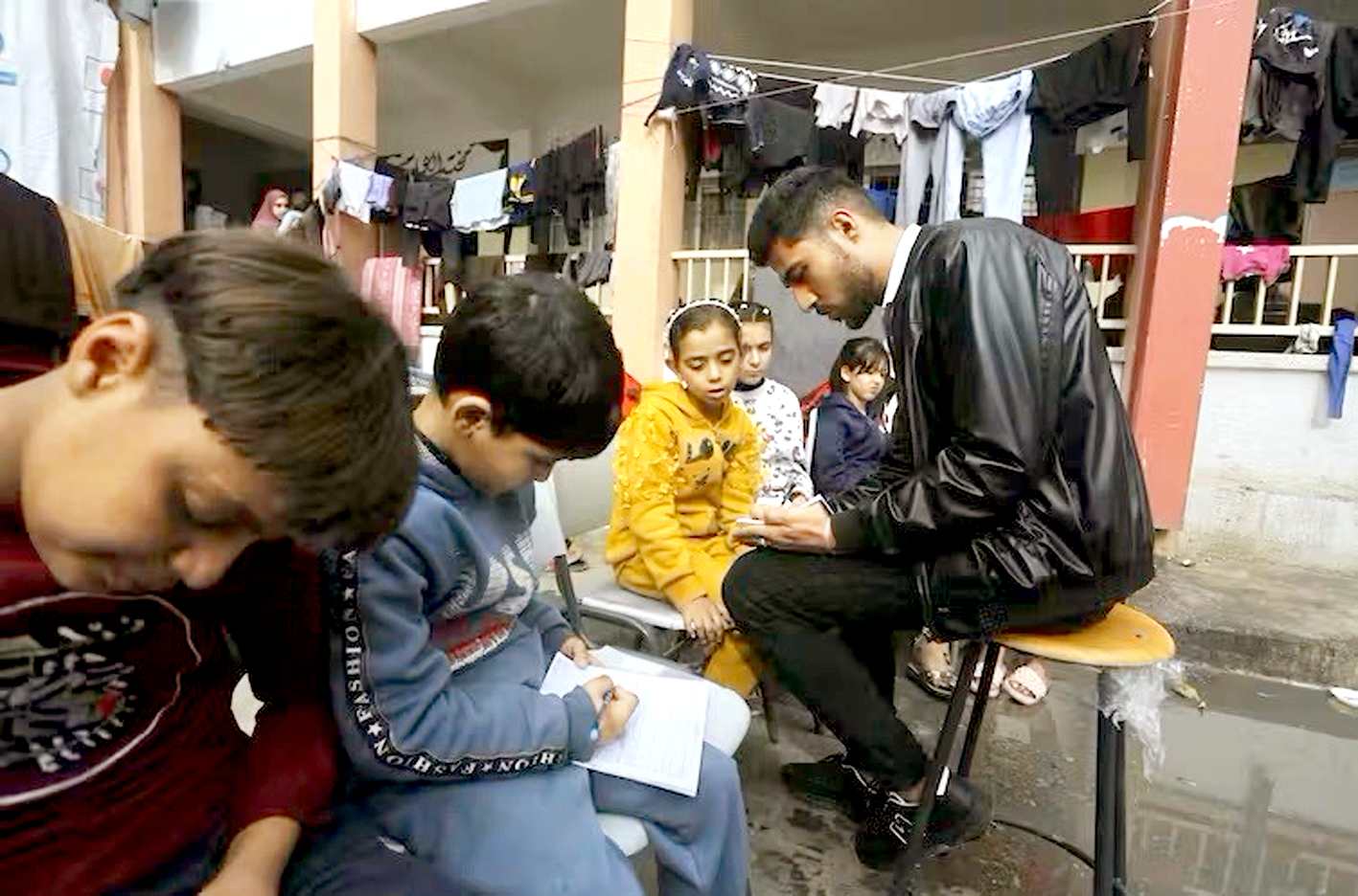 Giáo viên tiếng Anh Tariq Al-Annabi tổ chức một lớp học ngoài trời  do Liên hiệp quốc điều hành ở TP Rafah, vào ngày 26/11/2023,  trong thời gian ngừng bắn tạm thời - Nguồn ảnh: AP