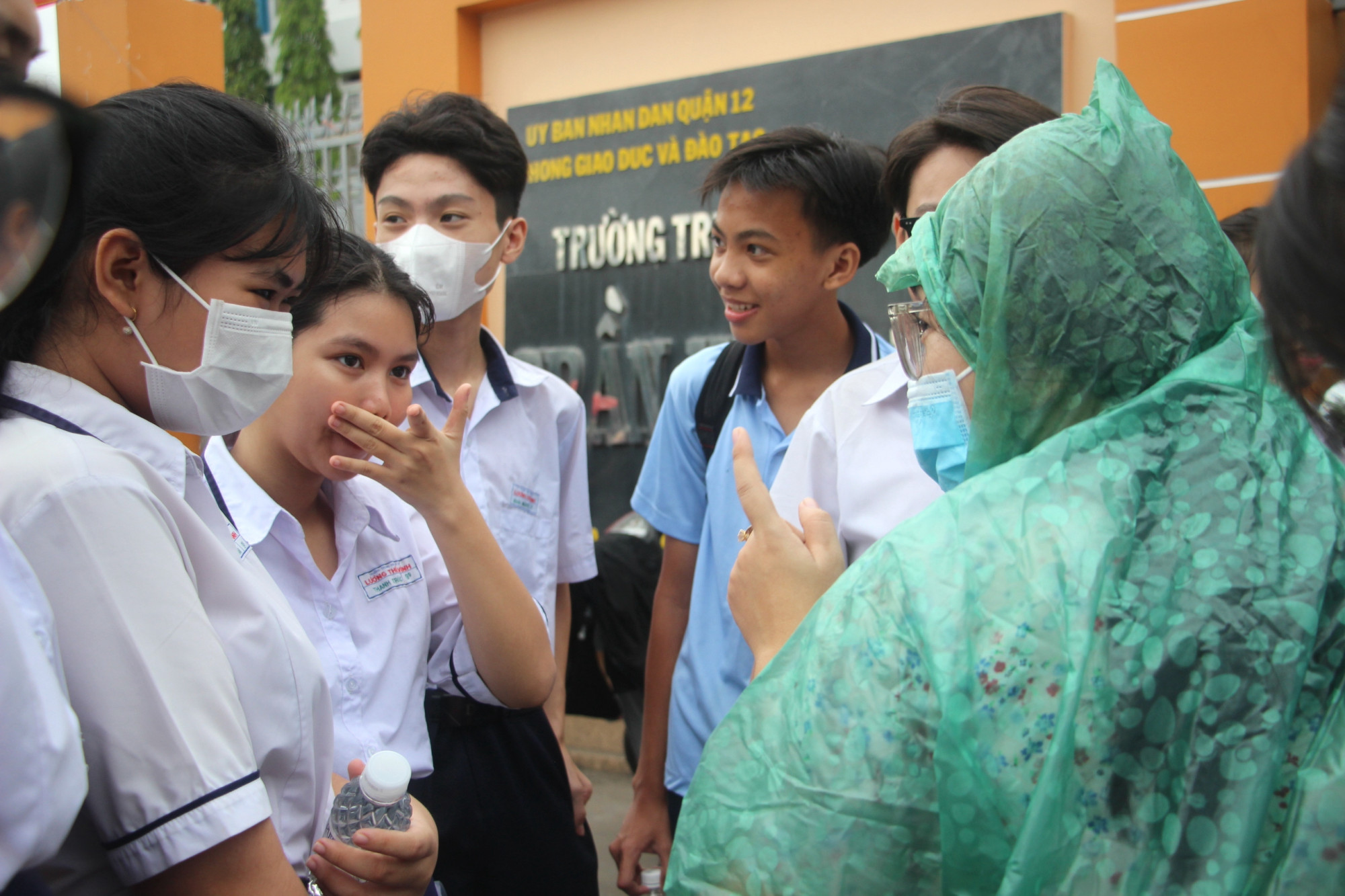 Tương tự, nhiều giáo viên khác có học sinh thi tại điểm trường này cũng tới rất sớm. Mưa nhỏ, cô vẫn cố gắng dặn dò, nhắc đi nhắc lại thí sinh từng chi tiết nhỏ 