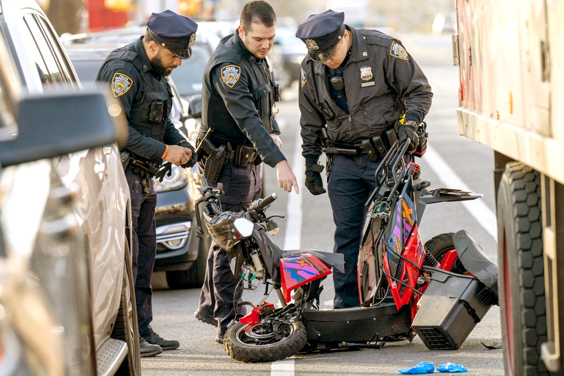 Cảnh sát xem xét hiện trường nơi một thanh niên lái xe máy điện đâm vào đuôi xe tải giao hàng ở New York, Mỹ vào tháng 4/2022 - Nguồn ảnh: New York Daily News