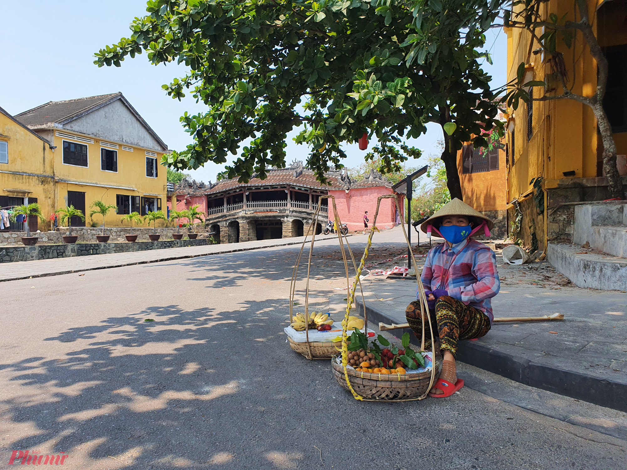 Người phụ nữ bán hàng rong ngồi gần Chùa Cầu sau đợt dịch COVID-19