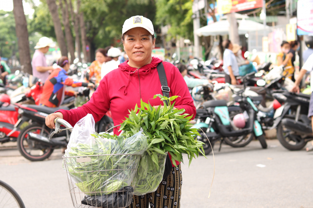 Chị Lê Thị Đào rời quê nhà Bình Định vào TPHCM mưu sinh với những xấp vé số. Ghé buổi chợ, chị nói thấy bồi hồi nhớ quê. Tại đây, chị cũng đã được tự tay chọn các loại rau củ tươi ngon mà hội tặng.