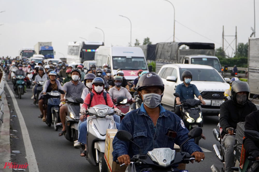 Khoảng 17h45, các phương tiện càng ngày càng tăng lên, cầu Bình Điền 1 trên Quốc lộ 1, đoạn qua huyện Bình Chánh, hướng từ TPHCM đi tỉnh Long An các liên tục chen chúc nhau đi qua cầu - Ảnh: Vũ Quyền