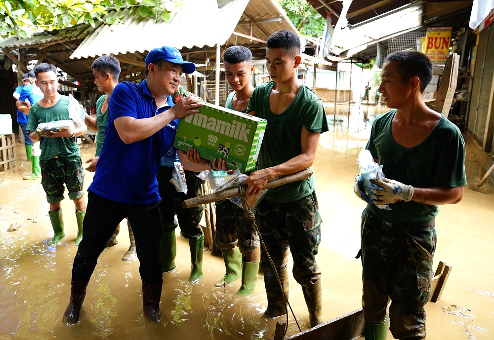 Vinamilk đem sữa, nước uống đến tận tay người dân và lực lượng đang làm nhiệm vụ khắc phục hậu quả bão lũ - Ảnh: Tịnh Không