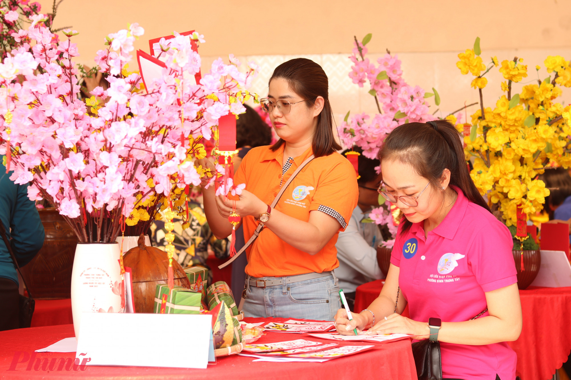 Các đội trang trí hoa mai, hoa đào và thiệp cho ngày tết. 