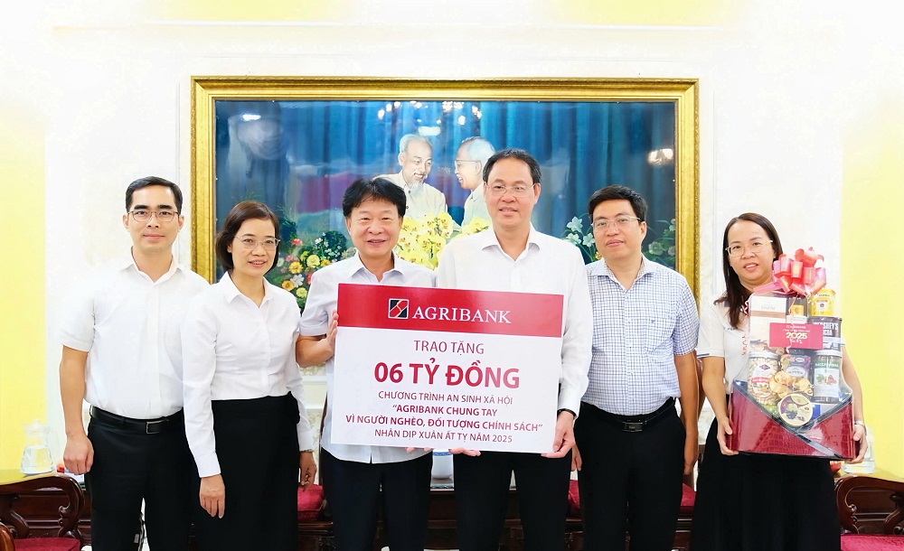 Ông Phạm Trung Kiên - Phó trưởng Văn phòng Đại diện Agribank khu vực miền Nam (bên trái) trao biển tượng trưng tặng kinh phí an sinh xã hội trên địa bàn TPHCM nhân dịp Tết Ất Tỵ 2025 - Ảnh: Agribank