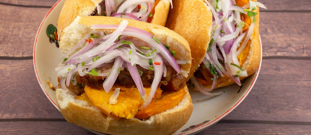 Pan con chicharrón là một món ăn sáng đặc trưng của Peru, đặc biệt phổ biến trong ẩm thực đường phố. Món này gồm bánh mì giòn (thường là bánh mì Pháp hoặc ciabatta) kẹp chicharrón—thịt ba chỉ lợn chiên giòn, cùng với khoai lang chiên và salsa criolla (hành tây thái mỏng trộn với chanh, ớt và rau mùi). Sự kết hợp giữa lớp vỏ bánh giòn, thịt lợn béo ngậy, khoai lang ngọt bùi và salsa chua cay tạo nên hương vị hài hòa, hấp dẫn.