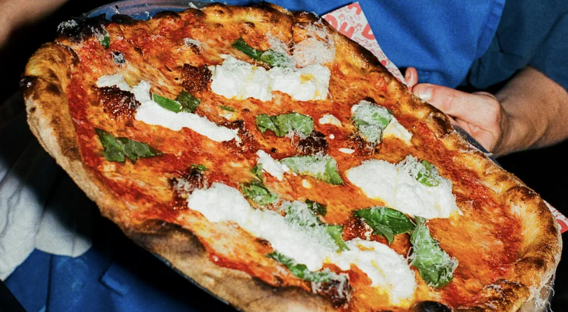 Nhà hàng Dough Hands, London, Anh. Chiếc pizza ngon ở đây tên là Jode. Bánh gồm: cà chua, phô mai mozzarella, xúc xích nduja, mật ong nóng, phô mai tươi stracciatella, phô mai cứng grano padano, húng quế cùng đế bánh giòn hoàn hảo - Ảnh: Dough Hands.