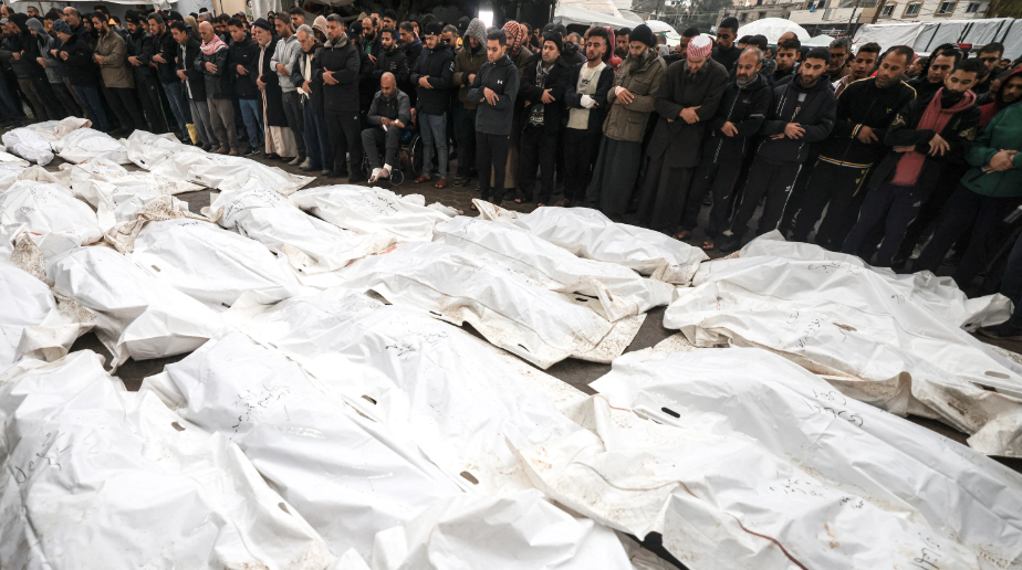 Người Palestine thương tiếc người thân của họ, những người thiệt mạng trong cuộc không kích của Israel vào trại tị nạn Al-Maghazi, trong một lễ tang tập thể tại bệnh viện Al-Aqsa ở Deir Al-Balah, miền trung Dải Gaza, vào ngày 25 tháng 12 năm 2023, trong bối cảnh các trận chiến đang diễn ra giữa Israel và nhóm chiến binh Hamas của Palestine. Mahmud Hams/AFP qua Getty Images