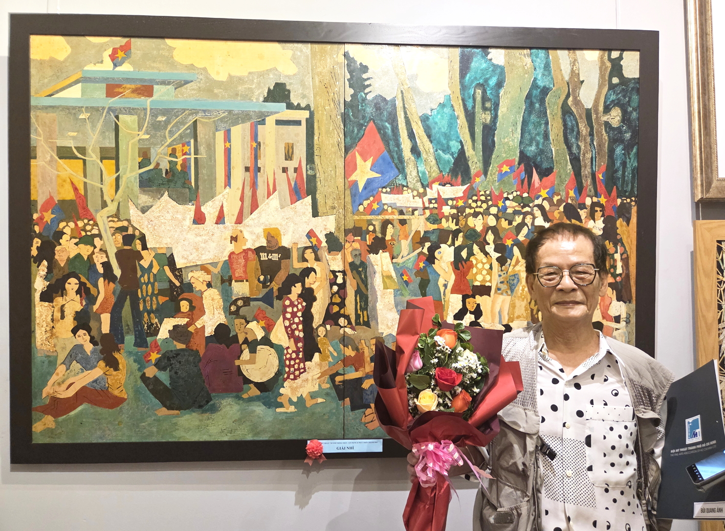 Họa sĩ Bùi Quang Ánh bên tác phẩm tranh sơn mài Mít tinh mừng Ủy ban Quân quản ra mắt tại TPHCM được vẽ lại từ bức ký họa của chính ông vào năm 1975