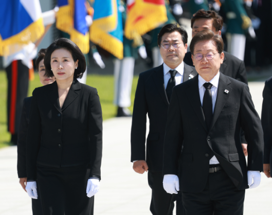 Tổng thống Lee Jae-myung (phải) và đệ nhất phu nhân Kim Hye-kyung đi bộ đến Tháp Tưởng niệm tại Nghĩa trang Quốc gia Seoul ở Dongjak-gu, Seoul, để bày tỏ lòng kính trọng hôm thứ Tư. (Ảnh hồ bơi văn phòng tổng thống qua Yonhap)
