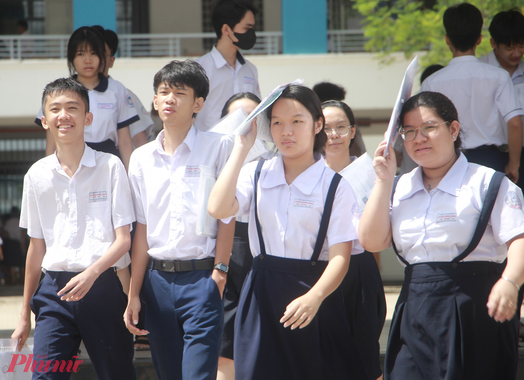 Thí sinh vui vẻ rời điểm thi sau khi hoàn thành bài thi môn tiếng Anh tại điểm thi Trường THCS Trần Hưng Đạo (quận 12) - Ảnh: Nguyễn Loan