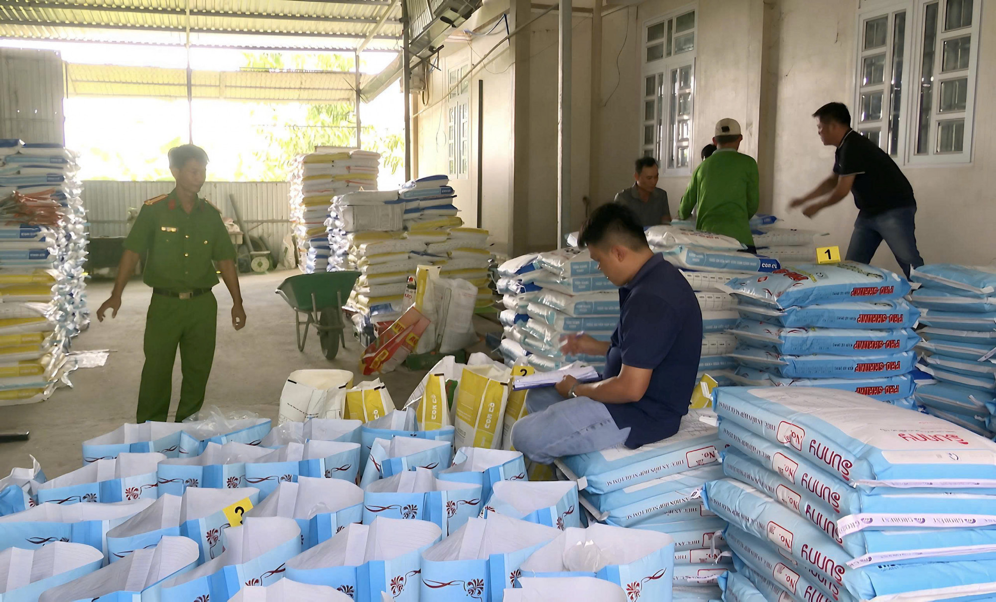 Lực lượng chức năng kiểm tra và bắt quả tang ông Hòa đang sản xuất hàng giả là thức ăn cho tôm. Ảnh: Trọng Nguyễn