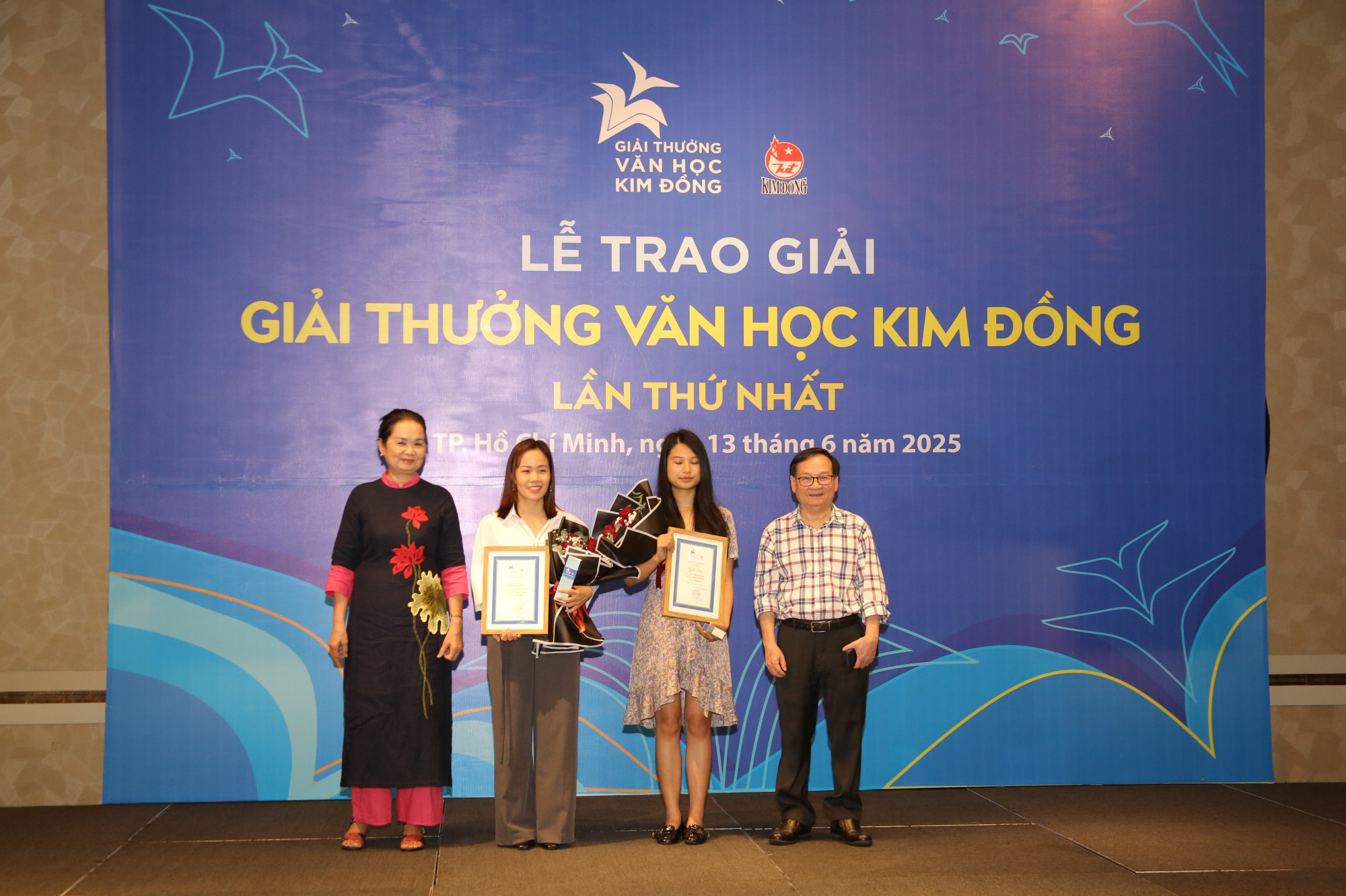 Nhà văn Bích Ngân - Chủ tịch Hội Nhà văn TPHCM (trái) và nhà văn Nguyễn Nhật Ánh (phải) trao giải cho các tác giả đoạt giải. Ảnh: NXB Kim Đồng