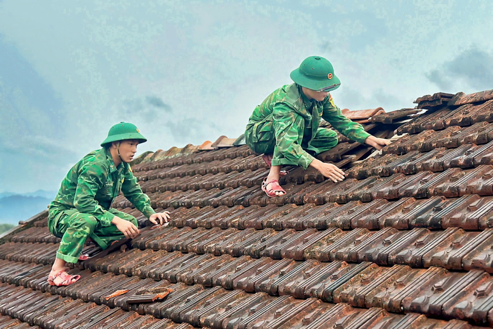 Miền Trung: Mưa lũ trái mùa cuốn đi tài sản và nguồn sống của dân Cán bộ, chiến sĩ hỗ trợ các hộ dân thôn Ka Nôn 1, xã Lâm Đớt, huyện A Lưới (TP Huế) sửa lại mái nhà bị hư hỏng do bão lũ - ẢNH: THUẬN HÓA