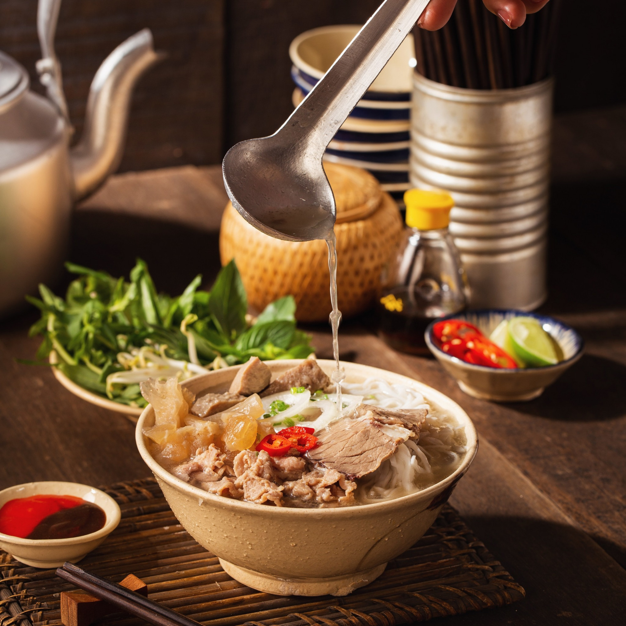 Nhà hàng Việt Nam Cô Chung. Nước phở được ninh trong 10 tiếng với đuôi bò cùng 12 loại thảo mộc và gia vị khác, đặc biệt không nêm đường và bột ngọt. Khách có thể chọn phở bò hoặc phở gà với đầy đủ rau, giá, chanh. Nhà hàng còn bán nhiều món ăn Việt Nam như: bánh xèo, các loại bánh Huế, nem nướng…. Địa chỉ: 4- 5 Lor Telok, mở cửa hằng ngày từ 11g - 22g. Giá bán từ 14,9 đô la Singapore/tô (khoảng 300.000 đồng) - Ảnh: Nhà hàng Việt Nam Cô Chung