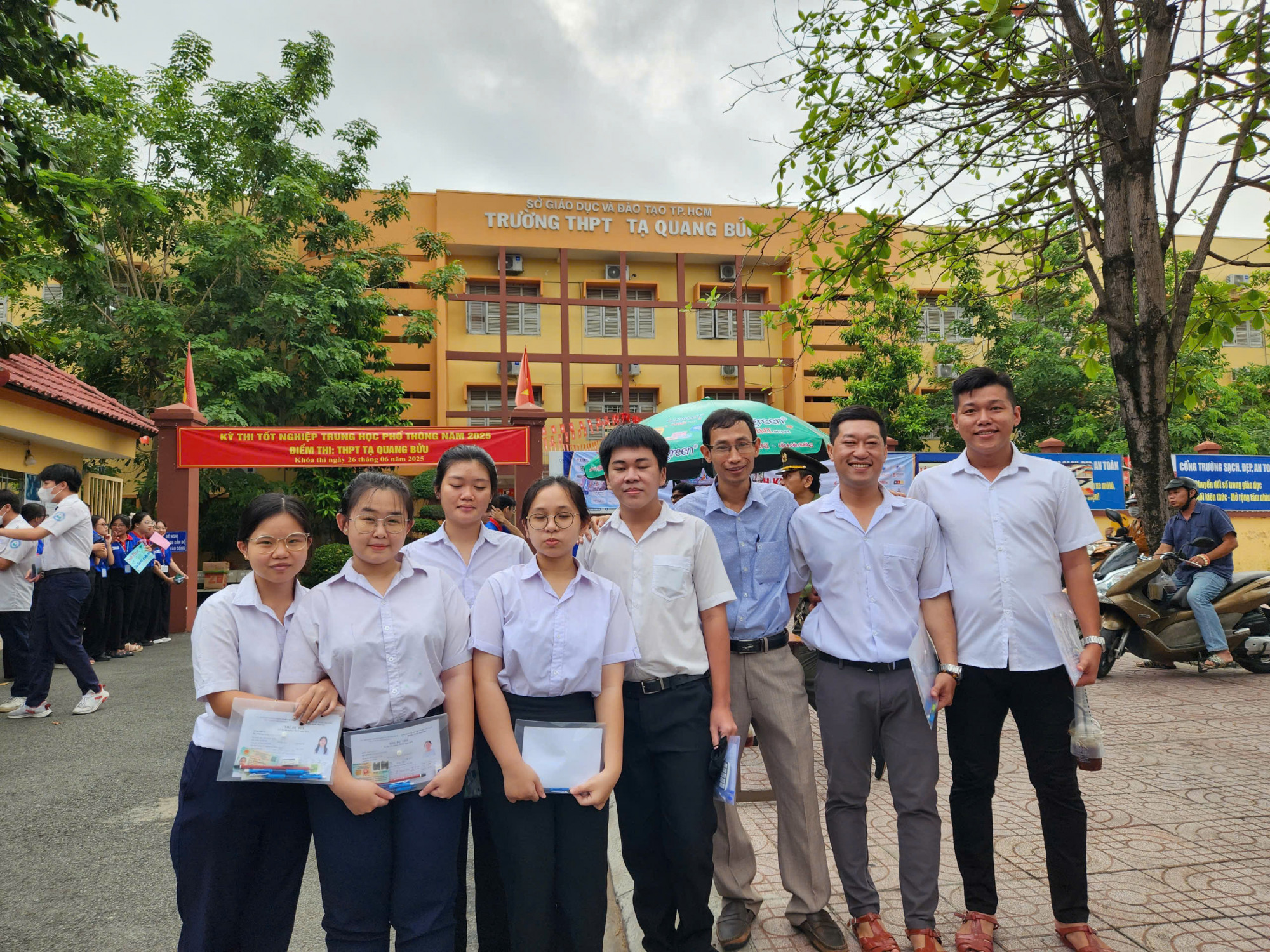 Anh Trần Tiến Phước (thứ 2 từ phải qua), thí sinh 40 tuổi đi thi tốt nghiệp THPT, kế bên thầy giáo của mình và các thí sinh năm nay - Ảnh: T.H.