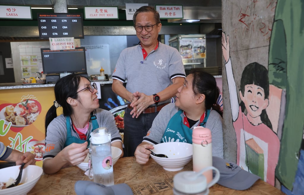 Koh Seng Choon (standing) founder and executive director of Project Dignity, speaks to staff members at Dignity Kitchen in Mong Kok. Photo: Edmond So