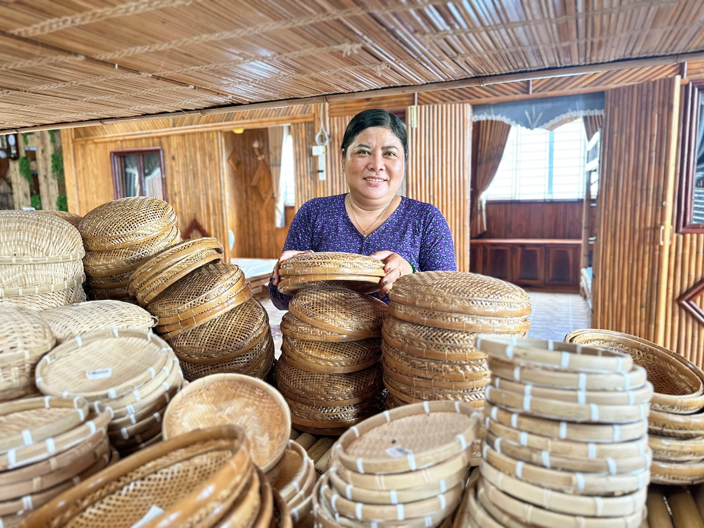 Chị Trương Thị Bạch Thủy bên các sản phẩm mây tre đan của hợp tác xã