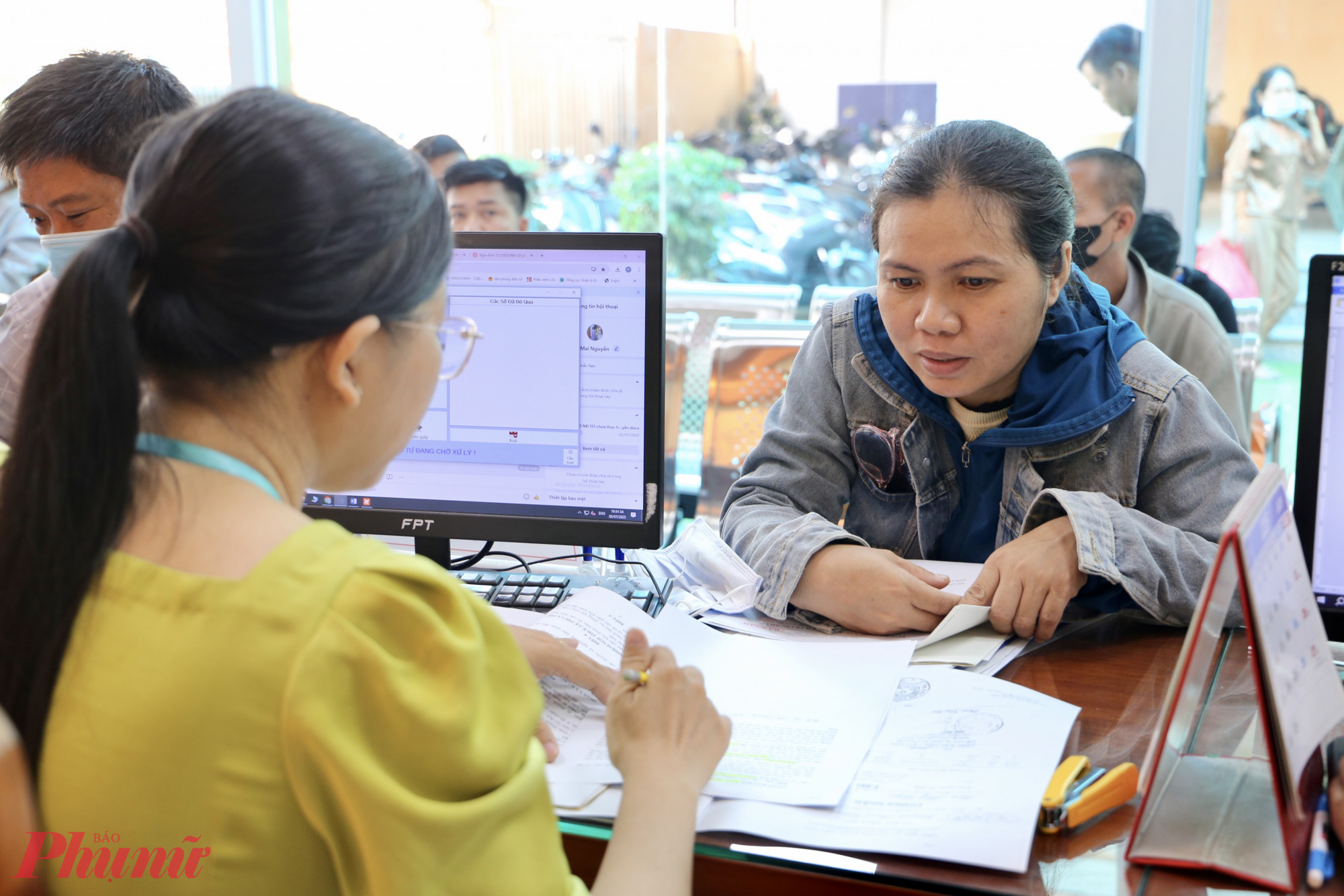 Cán bộ xã Vĩnh Lộc hướng dẫn người dân kê khai hồ sơ khi đến làm việc - Ảnh: Thanh Tâm