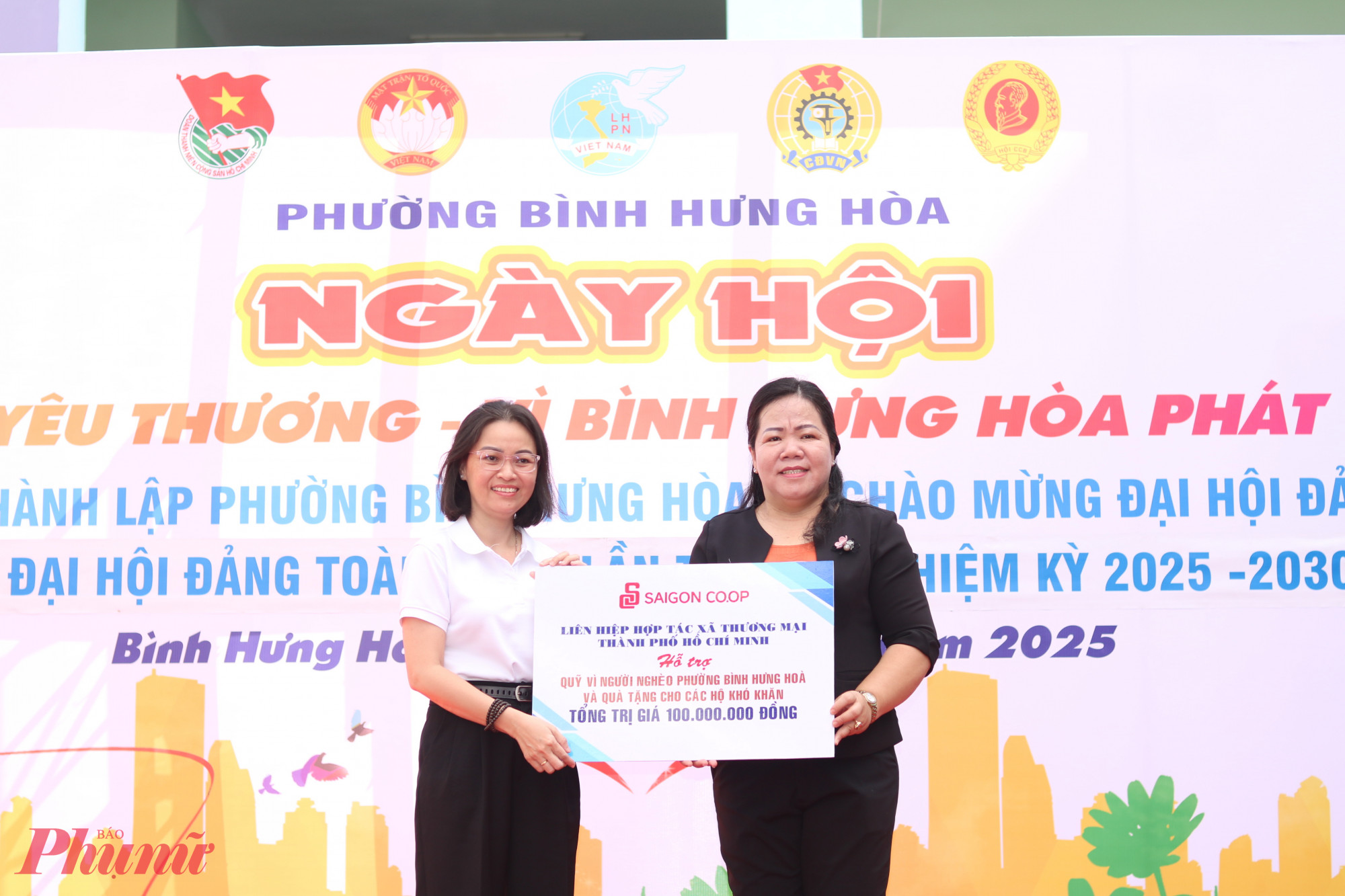 Bà Nguyễn Thanh Nguyệt (bìa phải) – Chủ tịch Uỷ ban MTTQ phường Bình Hưng Hoà, TPHCM – nhận bảng tượng trưng các gói hỗ trợ thực hiện ngày hội từ các cá nhân, đơn vị.