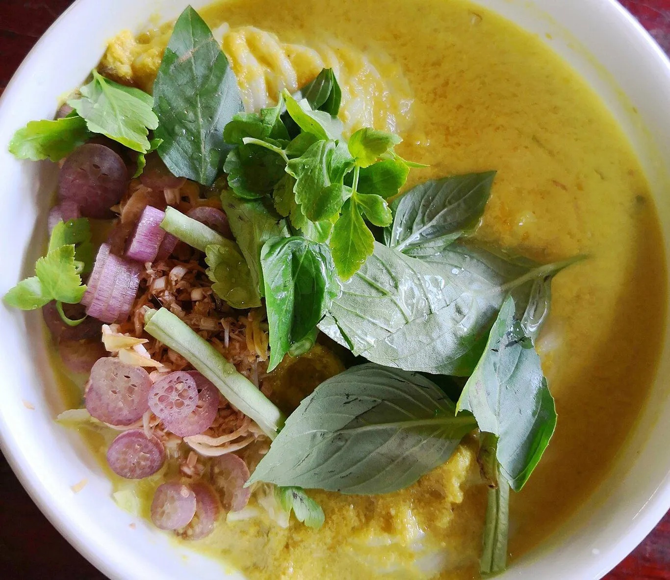 Num Banhchok là món bún truyền thống và linh hồn của nó là nước lèo. Nước được nấu từ cá lóc cùng các gia vị đặc trưng và mắm bò hóc. Nước lèo có màu vàng óng, ngọt thanh, béo nhẹ và thơm mùi cá, mắm nhưng không tanh. Cho nước lèo vào bún để thêm: rau thơm, giá, bông chuối bào, đậu đũa…cho ra tô bún thơm ngon - Ảnh: Thomas Wanhoff