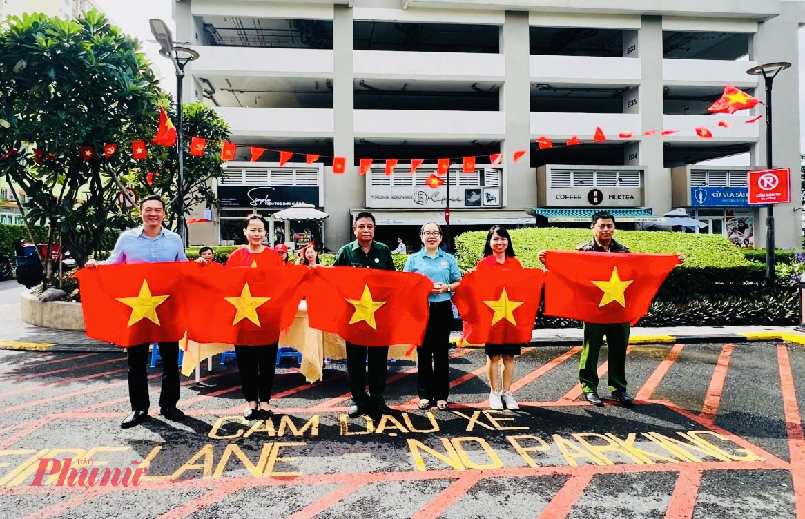 Bà Hoàng Mai Quỳnh Hoa – Chủ tịch Ủy ban MTTQ Việt Nam phường Bình Thạnh trao tặng “Cờ Tổ quốc” cho người dân ở chung cư Richmond City, khu phố 44