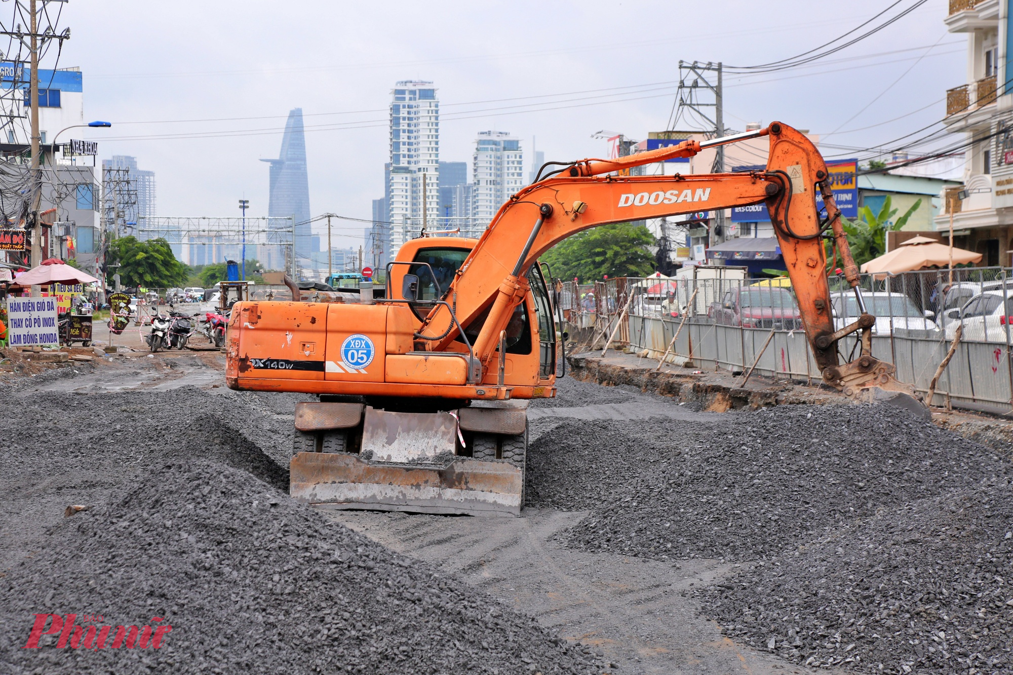 Máy xúc đang đào đất cát san lấp mặt bằng tuyến đường