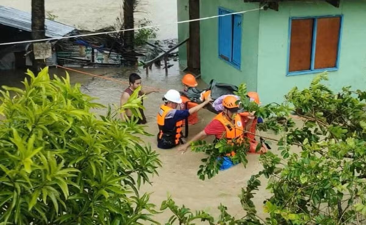 Lực lượng cứu hộ sơ tán một người dân đến nơi an toàn hơn khi lũ lụt dâng cao do bão nhiệt đới Opong (bão Bualoi) ở khu vực Odiongan, tỉnh Romblon, Philippines vào ngày 26/9 - Ảnh: Lực lượng Bảo vệ Bờ biển Philippines