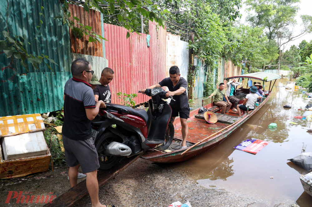 Người dân khẩn trương di dời đồ đạc, tài sản, vật nuôi khỏi khu vực bị ngập úng.