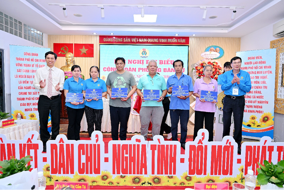 Đại diện lãnh đạo phường Bàn Cờ và đơn vị tài trợ trao tặng thẻ bảo hiểm y tế cho đoàn viên, người lao động khó khăn. Ảnh: BTC