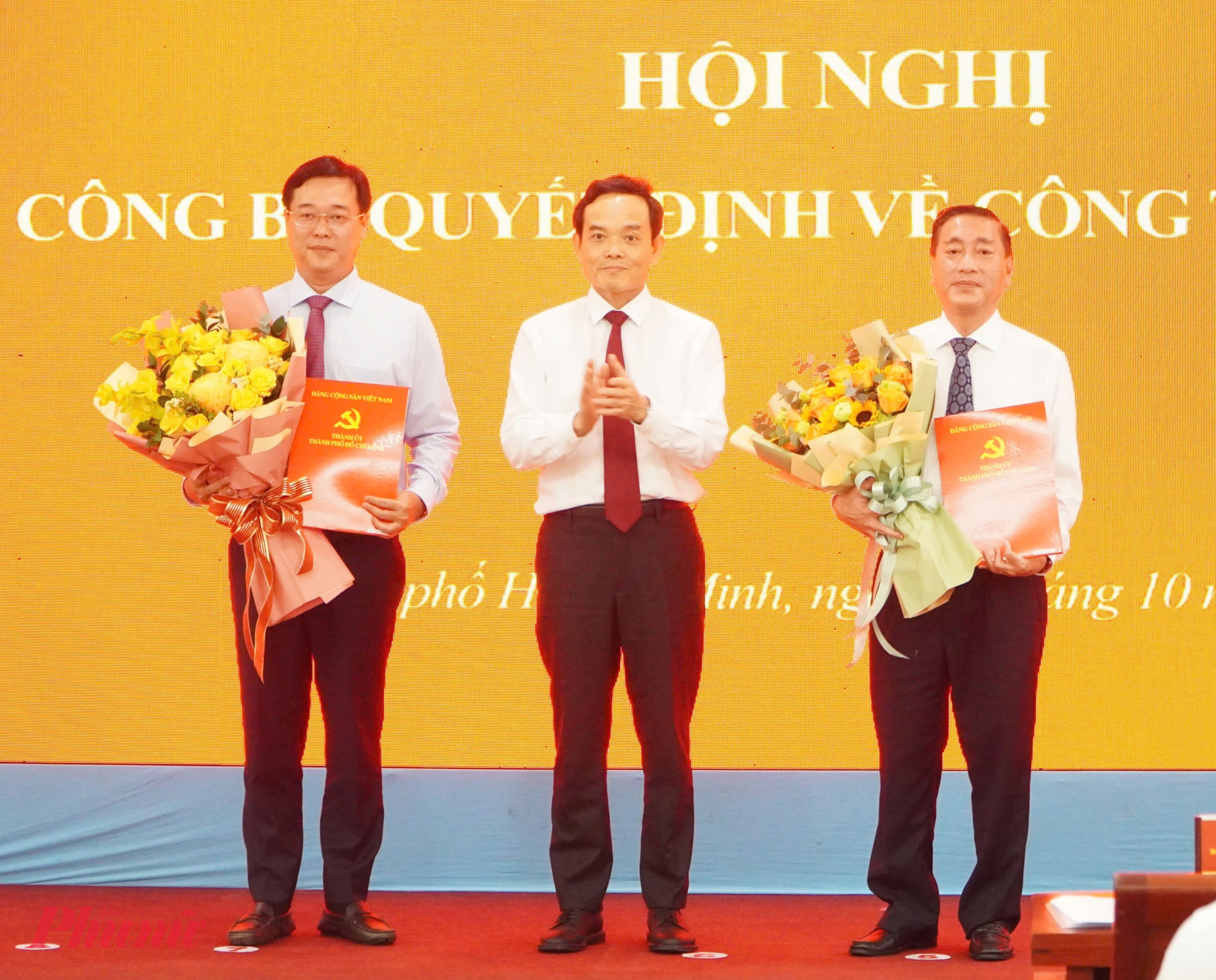 Ông Trần Lưu Quang, Bí thư Trung ương Đảng, Bí thư Thành ủy TPHCM trao quyết định trao quyết định và chúc mừng ông Lê Quốc Phong (bìa trái) và ông Phạm Thành Kiên (bìa phải)