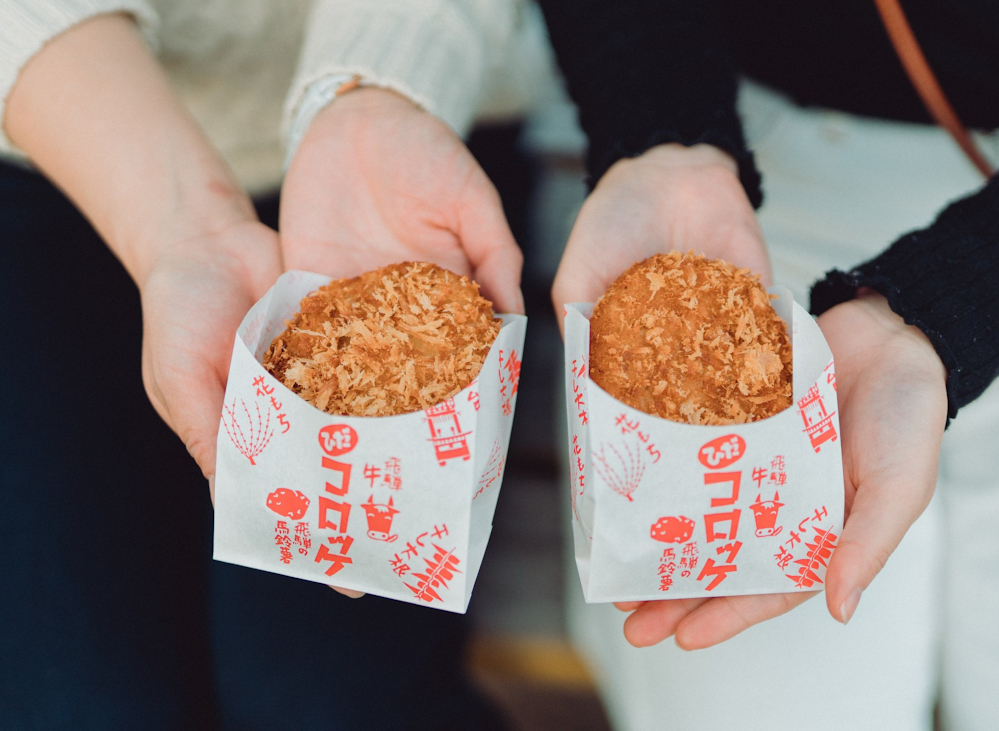 Các món ăn chế biến từ bò Hida như korokke (bánh khoai tây nhân thịt), thịt nướng, hay gohei mochi (cơm nướng xiên phủ sốt) luôn nằm trong danh sách “phải thử”. Ngoài ra, du khách có thể thưởng thức ramen địa phương, ghé thăm các hầm rượu sake lâu đời, hoặc thư giãn trong những quán cà phê nhỏ mang đậm dấu ấn bản địa. 