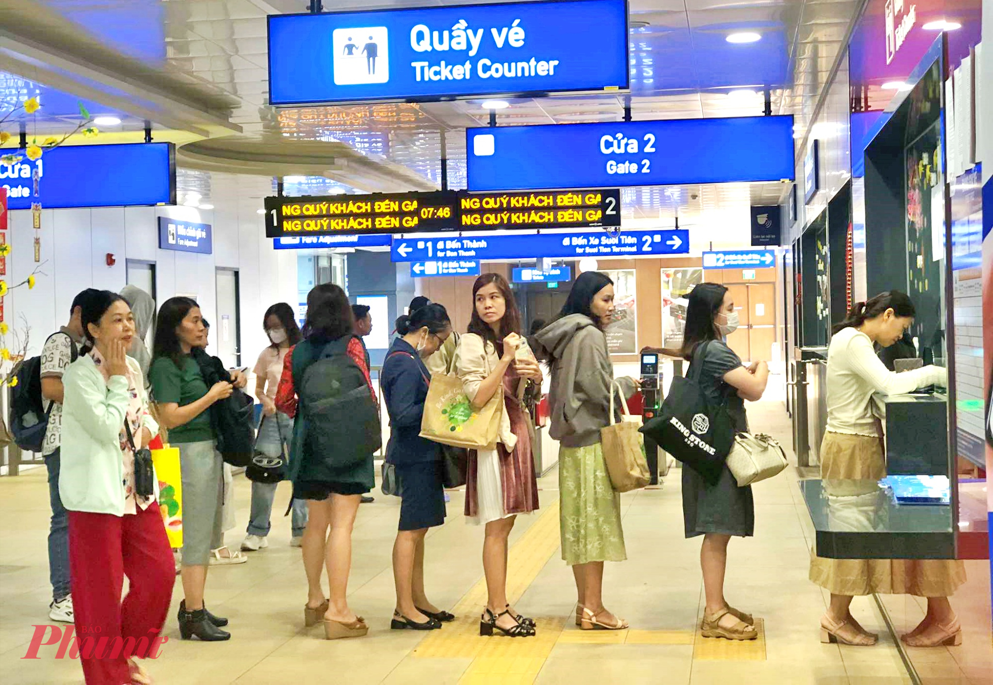 Hành khách xếp hàng mua vé đi metro số 1 - Ảnh: Nguyễn Văn