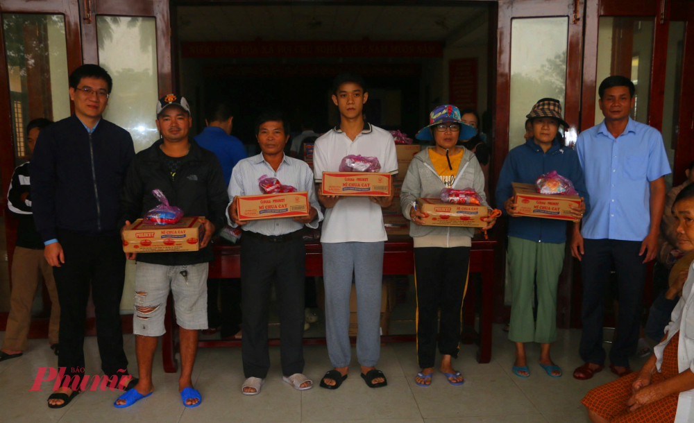 Anh Võ Đức Quang-  Bí thư Đoàn Thanh niên đại diện Báo và Phát thanh, Truyền hình Huế  tặng quà cho bà con rốn lũ xã Quảng Điền