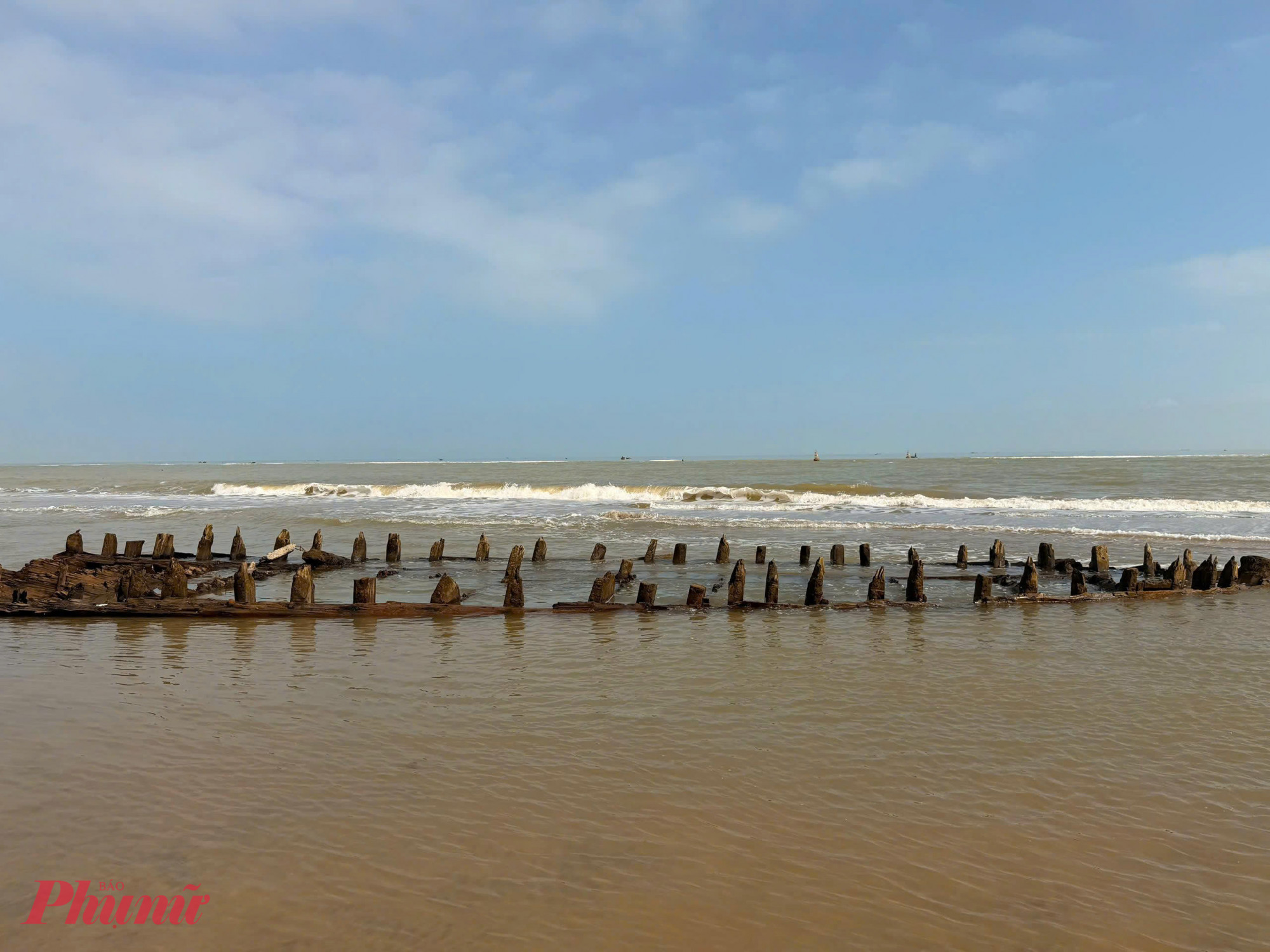 Bão lụt, sóng biển đánh vào, đất cát bị trôi ra biển nên xác tàu mới trồi lên.