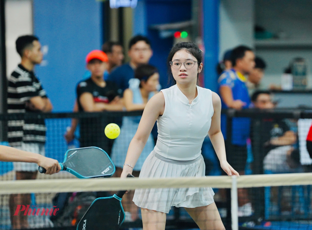 Vận động viên Phạm Gia Nghi (phường Bình Trưng) xuất hiện trong trẻo với đầm trắng, cô chia sẻ đây là lần đầu tiên tham gia giải Picleball và cô đến với tinh thần học hỏi, trải nghiệm là chính.