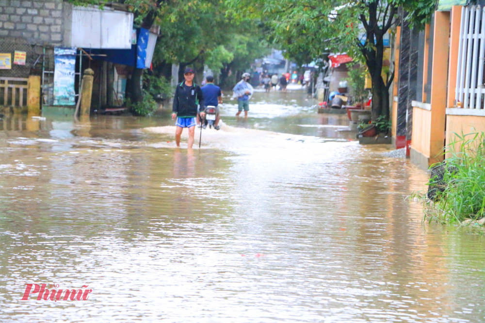 Bà con làng lụt Vân Dương gọi điện nhắc nhau kê dọn đồ đạc lên cao để đối phó với lũ mới