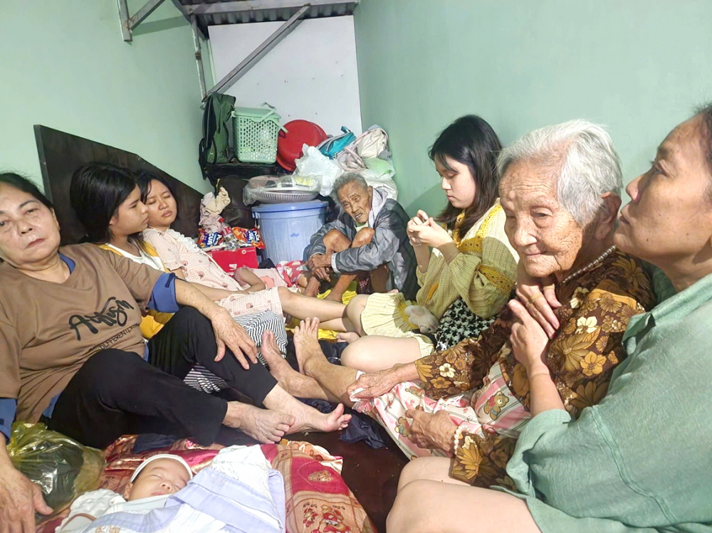 Người già, trẻ em ở tỉnh Khánh Hòa tránh lũ trên một căn gác nhỏ - ẢNH: TRẦN HẰNG