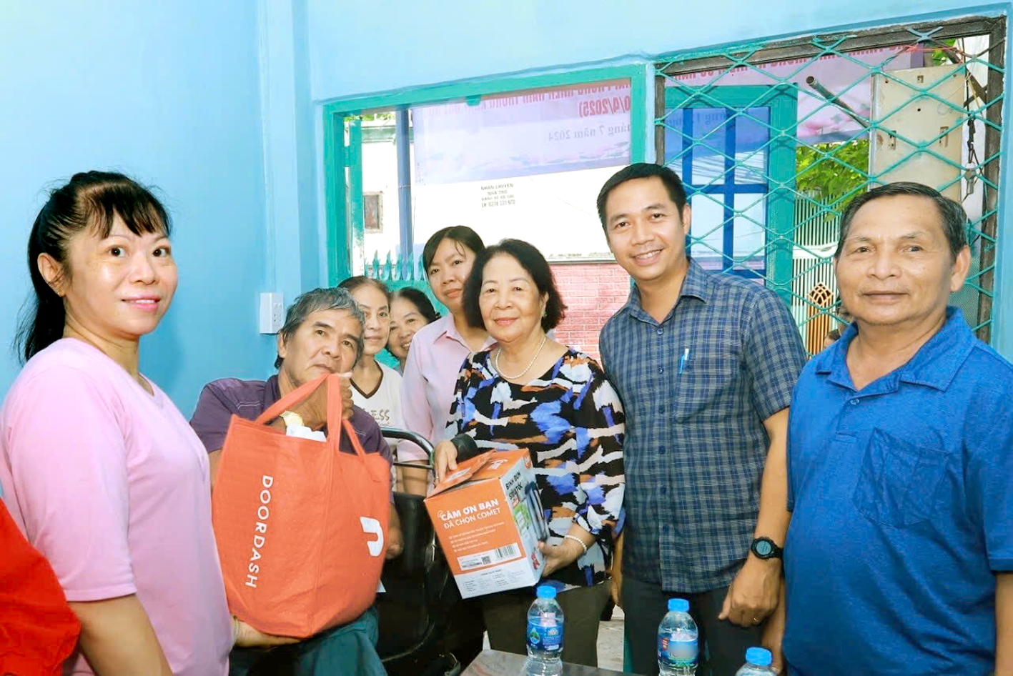 Bà Nguyễn Thị Tơ (thứ ba từ phải qua) trao quà cho ông Huỳnh Văn Sơn trong ngày bàn giao nhà