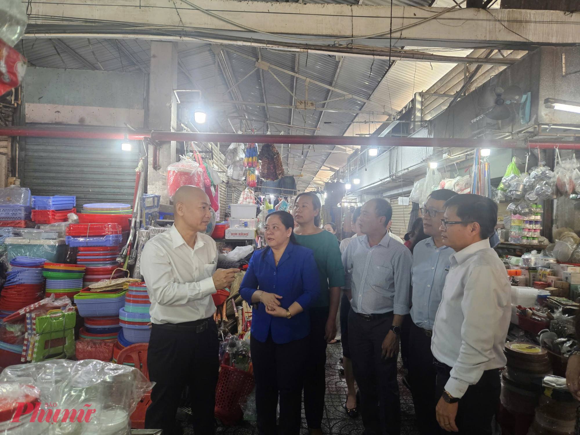 Bà Bùi Thị Ánh Nguyệt (áo xanh) trao đổi với lãnh đạo Sở Công Thương TPHCM về tình hình kinh doanh tại chợ Phạm Văn Hai