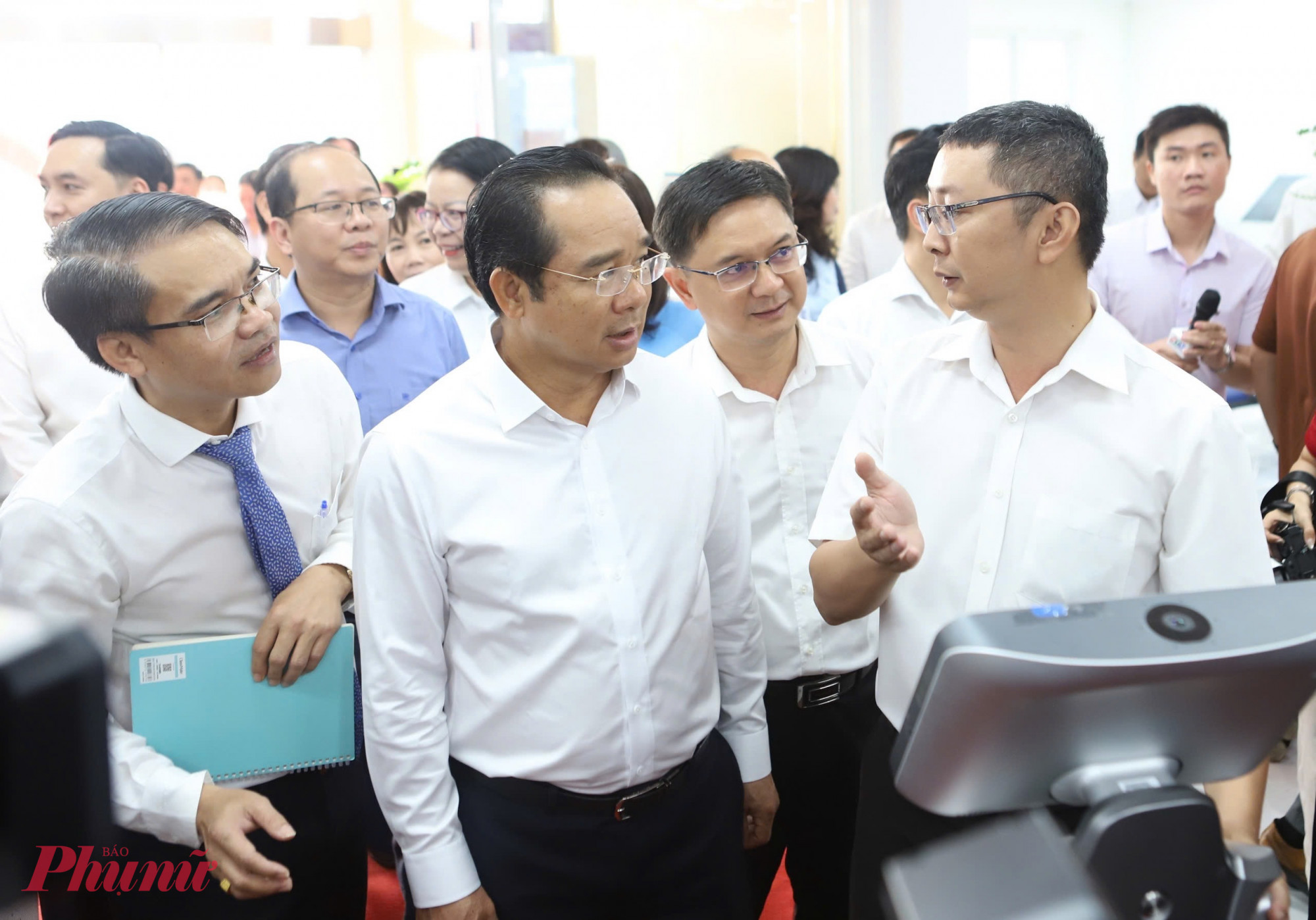 Ông Nguyễn Văn Được - Chủ tịch UBND TPHCM cùng lãnh đạo các sở ban ngành trải nghiệm robot tại trung tâm - Ảnh: Thanh Tâm