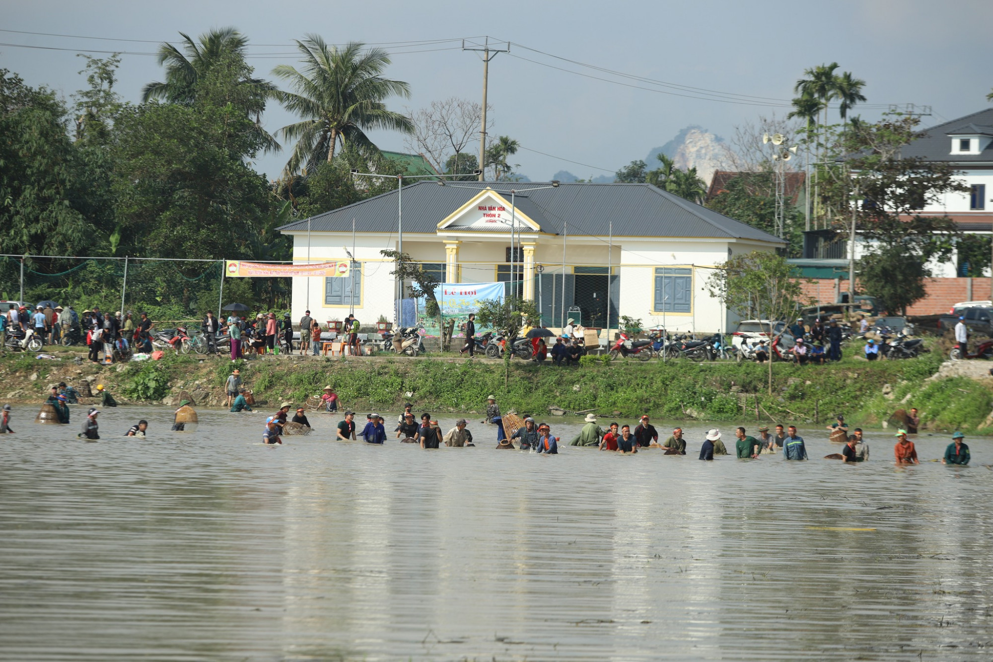Hơn 100 nơm thủ thi nhau trổ tài bắt cá ngày đầu năm - Ảnh: Rạng Đông