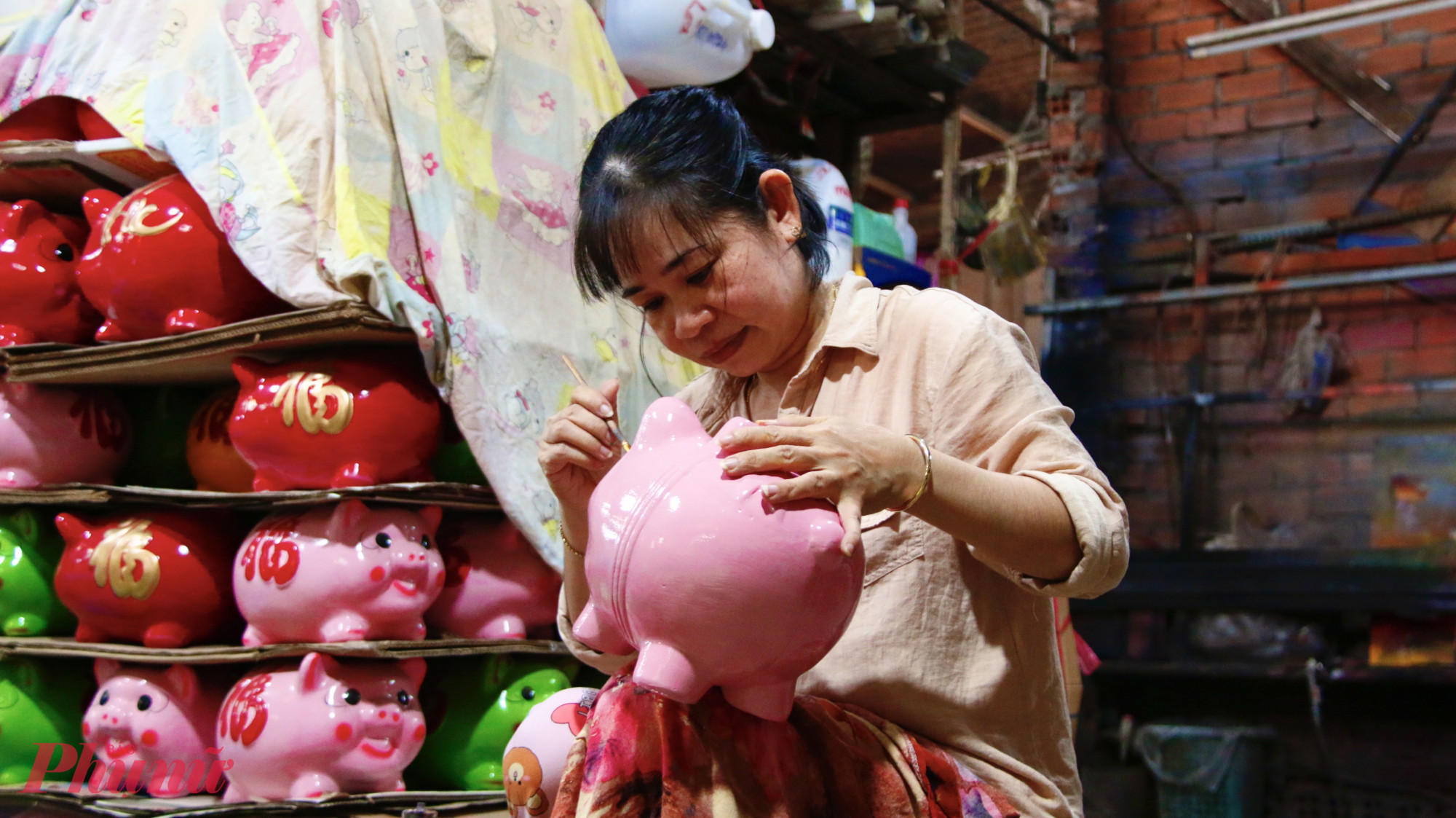 Heo đất được các nghệ nhân tỉ mỉ trang trí, hoàn thiện trước khi đưa ra thị trường tại cơ sở sản xuất heo đất Hà An.