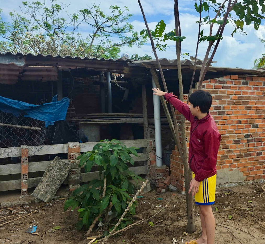 Khang chỉ phía sau nhà, nơi hấy một phi công bị thương-Ảnh: ĐH